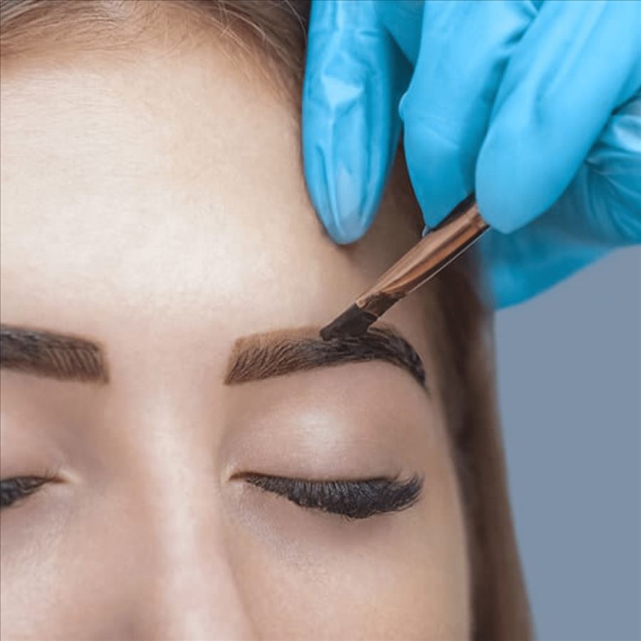 Henna tint being brushed onto an eyebrow