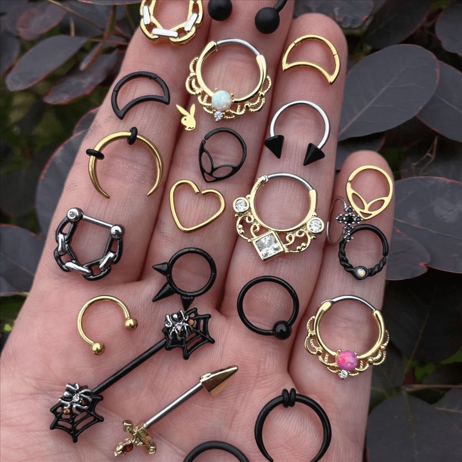 Hand holding a selection of rings, clickers and barbells