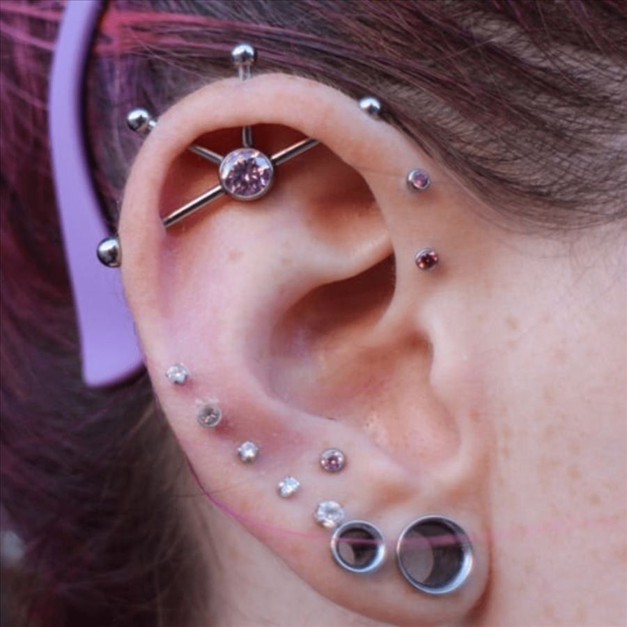 Ear with industrial, helix and lobe piercings